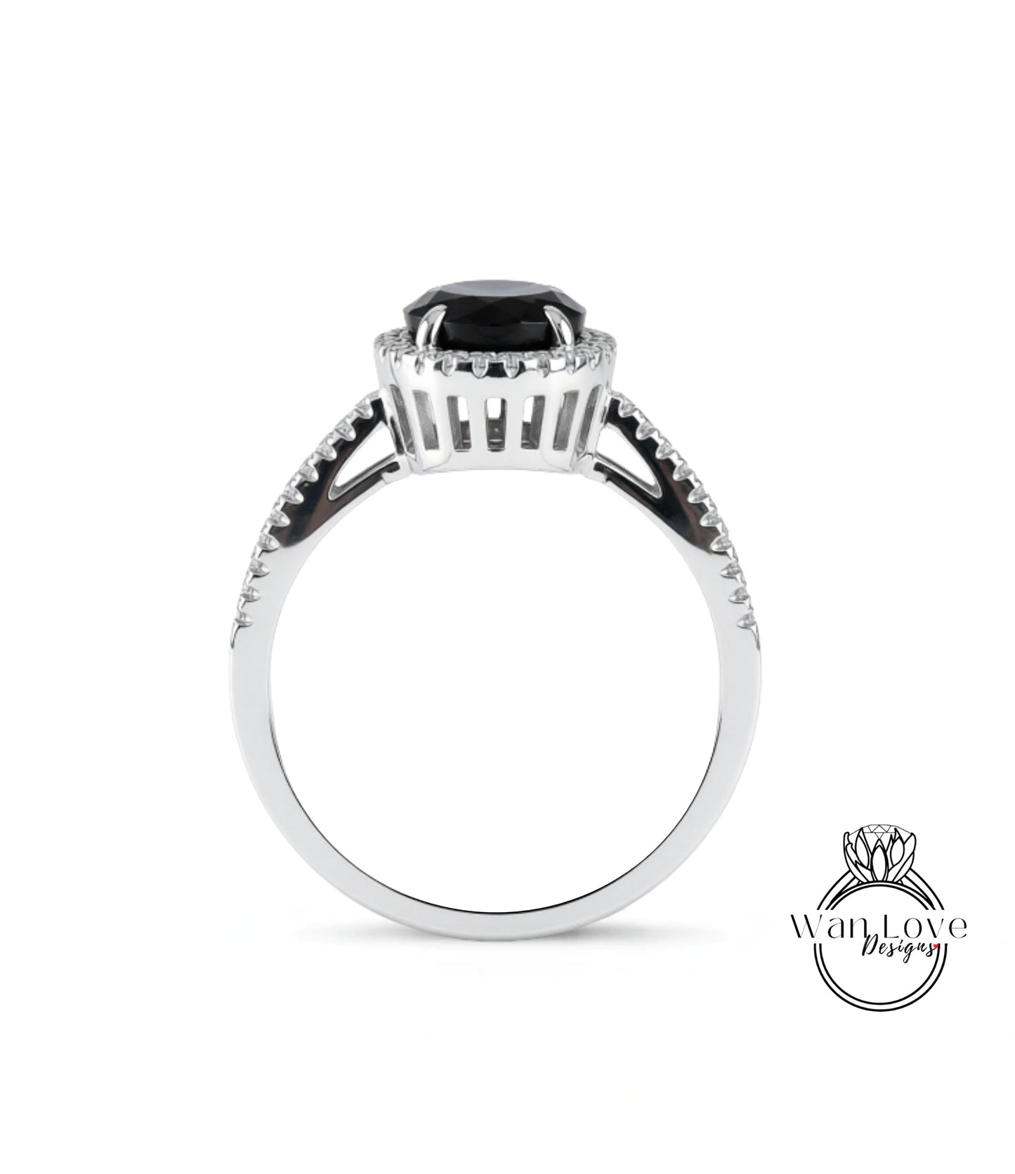 A silver ring with a large black gemstone, possibly a diamond, at the center.
