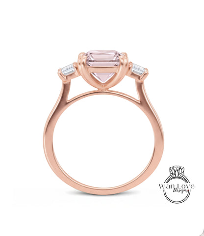 A rose gold ring with a large pink gemstone set in the center, surrounded by smaller stones.