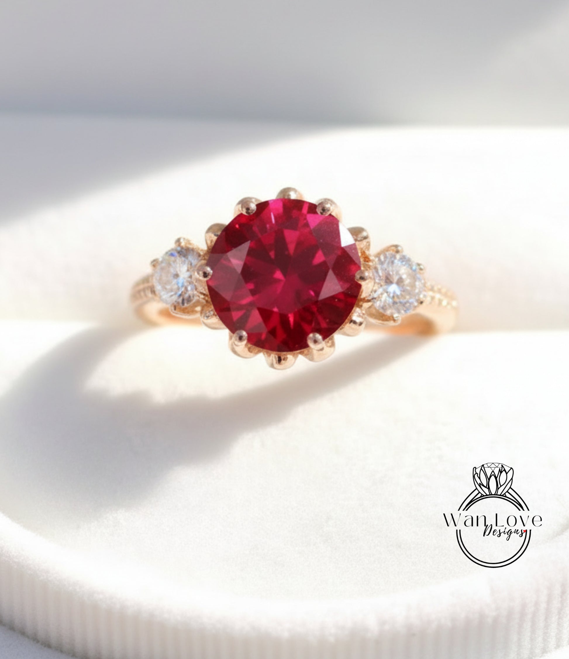 A gold ring with a large red gemstone, possibly a ruby, set in the center.