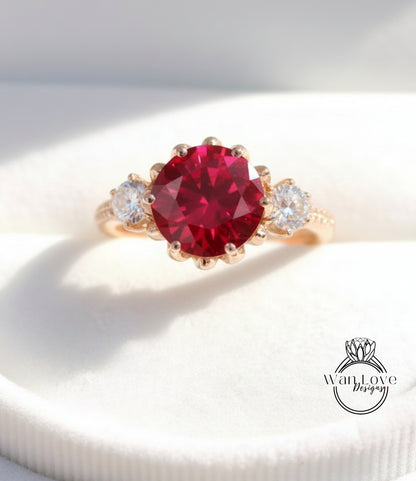 A gold ring with a large red gemstone, possibly a ruby, set in the center.