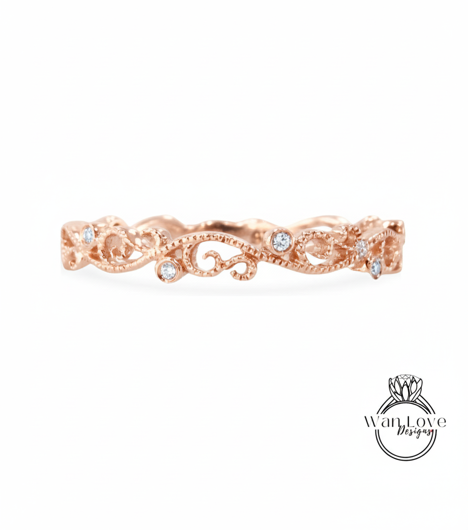 a rose gold ring with a delicate floral design and small diamonds set in it.