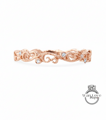 a rose gold ring with a delicate floral design and small diamonds set in it.
