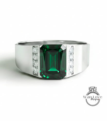 A silver ring with a large, green gemstone in the center.