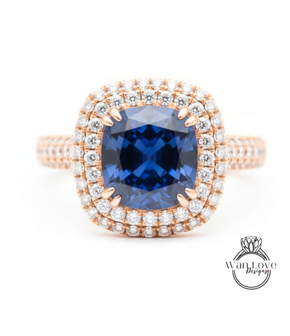 A stunning diamond ring with a large blue gemstone at the center, surrounded by a halo of smaller diamonds.