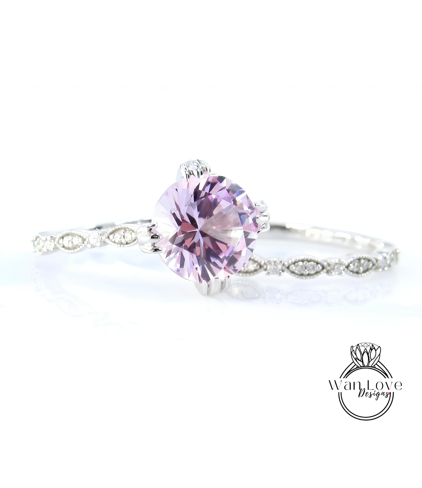 A close-up of a beautiful purple gemstone set in a silver ring, with a delicate band around it.