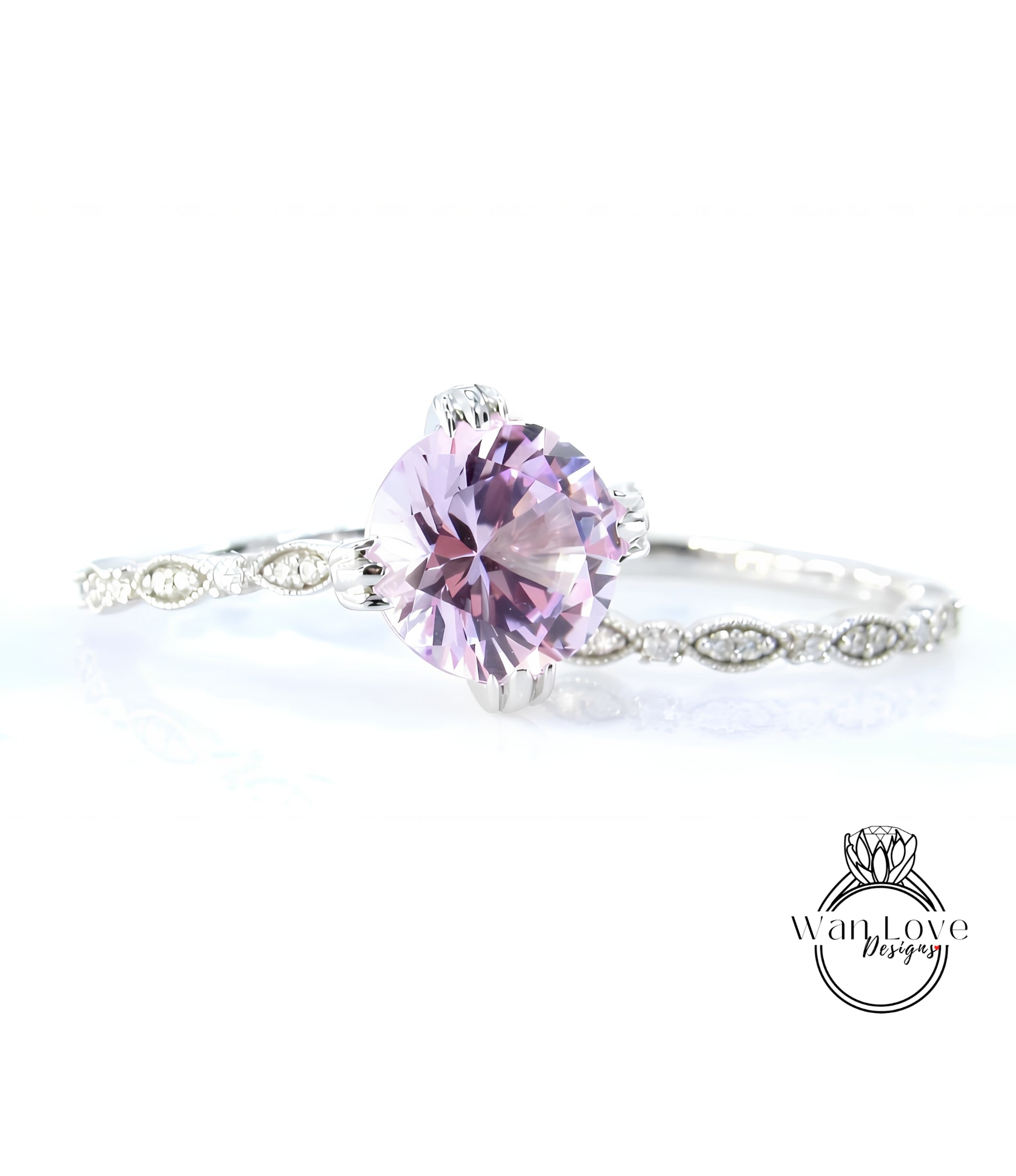 A close-up of a beautiful purple gemstone set in a silver ring, with a delicate band around it.