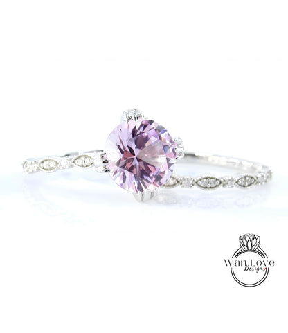 A close-up of a beautiful purple gemstone set in a silver ring, with a delicate band around it.