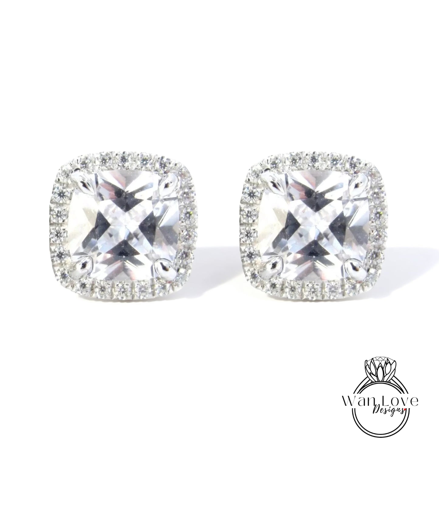 A pair of elegant earrings with large, clear gemstones set in a halo of smaller diamonds.