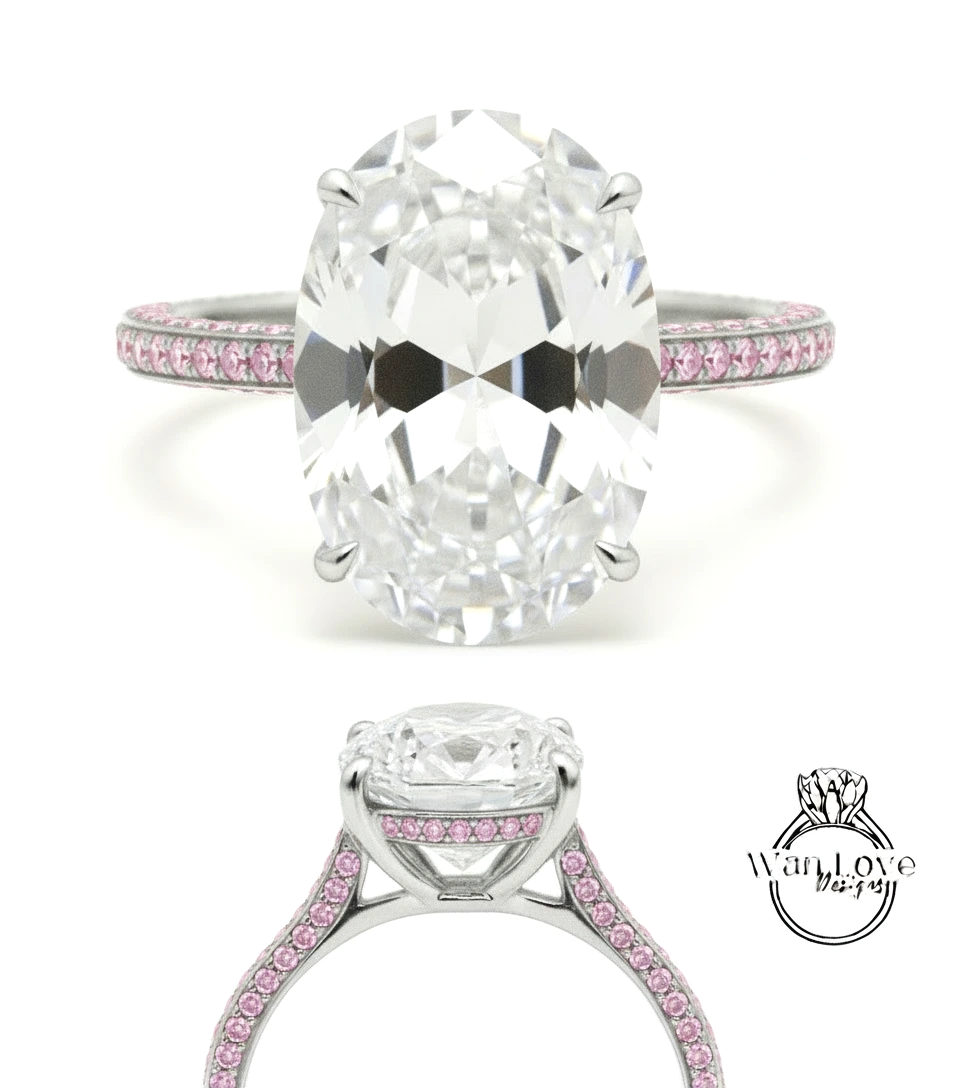 A large oval-shaped diamond engagement ring with a silver band and pink gemstones.