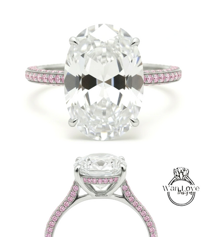 A large oval-shaped diamond engagement ring with a silver band and pink gemstones.