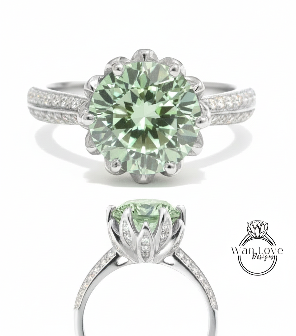 A stunning green gemstone ring with a large central stone surrounded by smaller stones, set in a silver band with a delicate flower-like design.