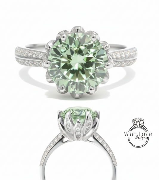 A stunning green gemstone ring with a large central stone surrounded by smaller stones, set in a silver band with a delicate flower-like design.