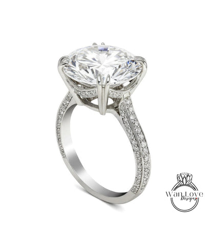 A large, sparkling diamond engagement ring with a prominent center stone and intricate metalwork detailing.