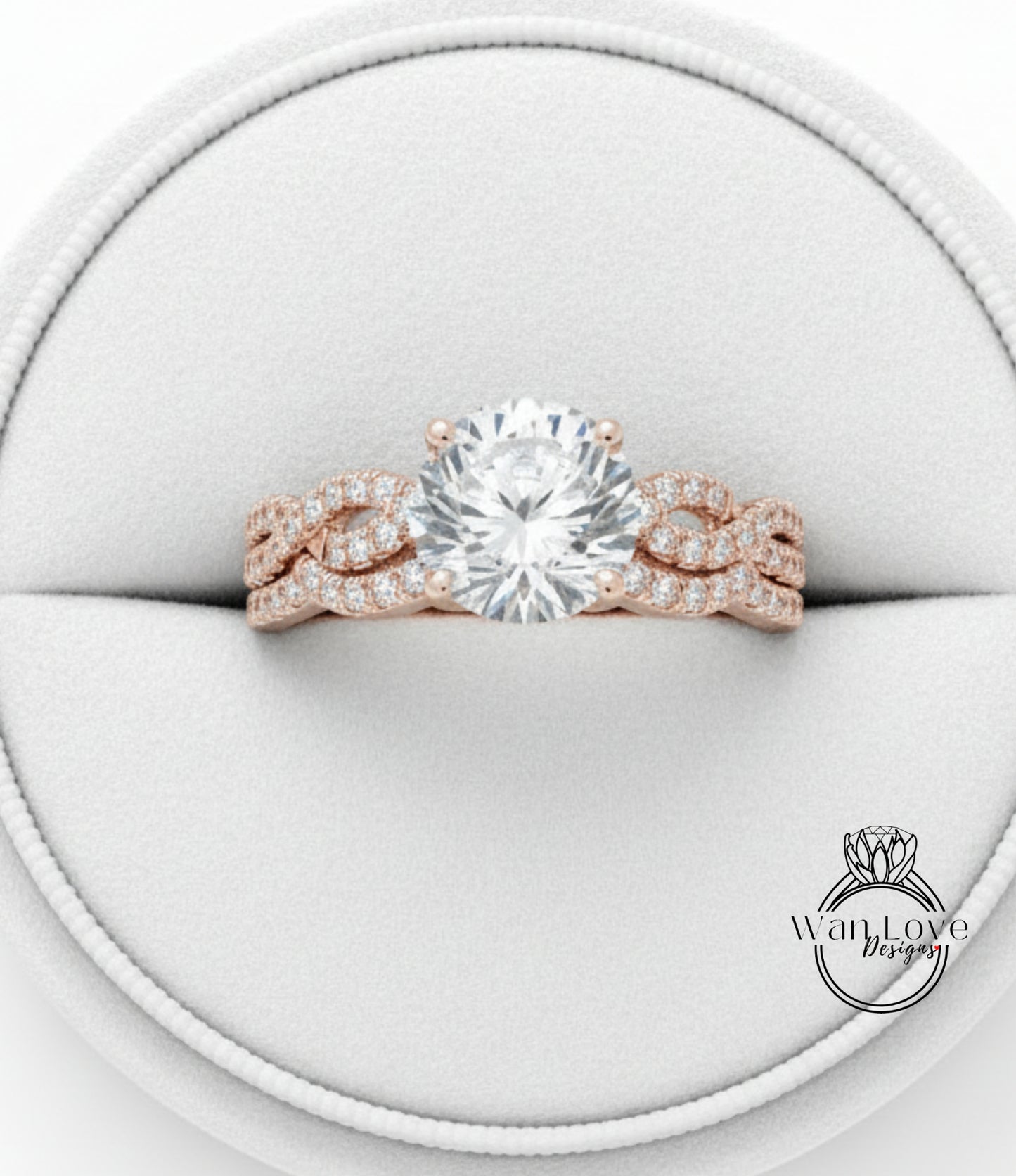 A beautiful engagement ring with a large round diamond set in a rose gold band, displayed in a white jewelry box.