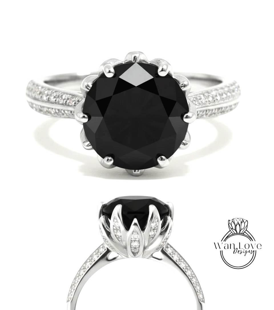 A silver ring with a large black diamond as the centerpiece, surrounded by smaller diamonds.