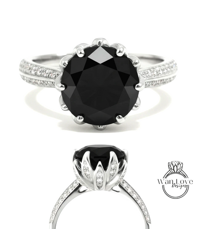 A silver ring with a large black diamond as the centerpiece, surrounded by smaller diamonds.