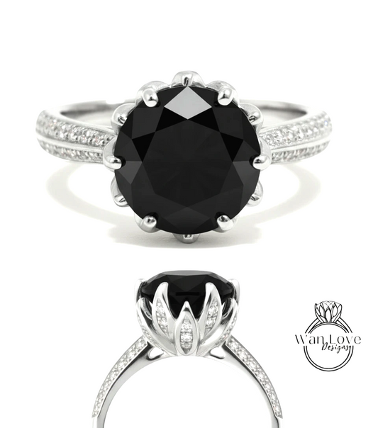 A silver ring with a large black diamond as the centerpiece, surrounded by smaller diamonds.