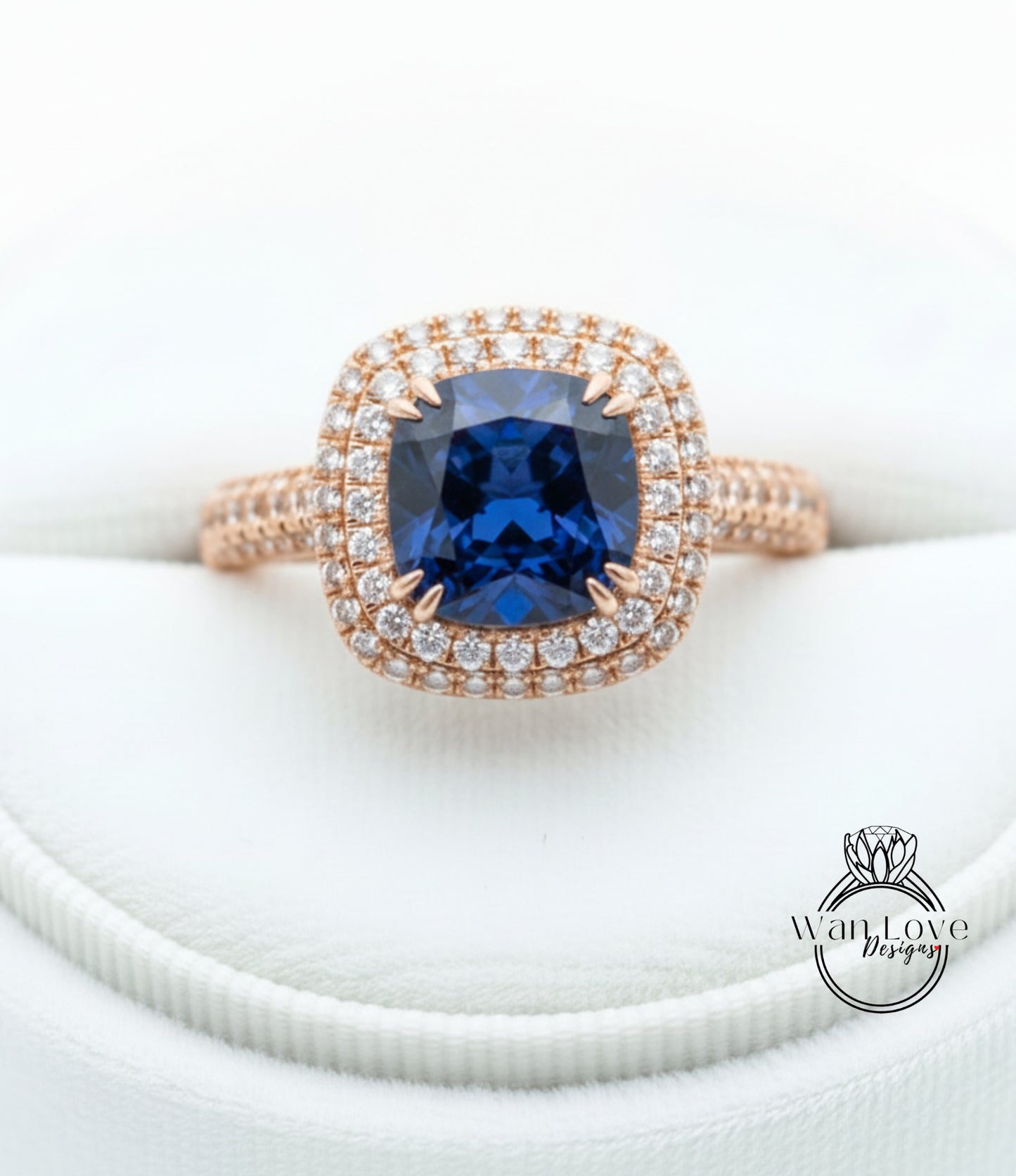 A close-up image of a gold ring with a large blue gemstone, likely a sapphire, surrounded by a halo of smaller diamonds.