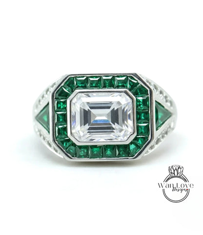 A ring with a large central diamond surrounded by smaller diamonds and green gemstones.