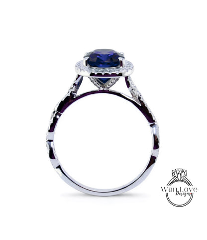 A silver ring with a large blue gemstone, possibly a sapphire, set in a halo of smaller diamonds.