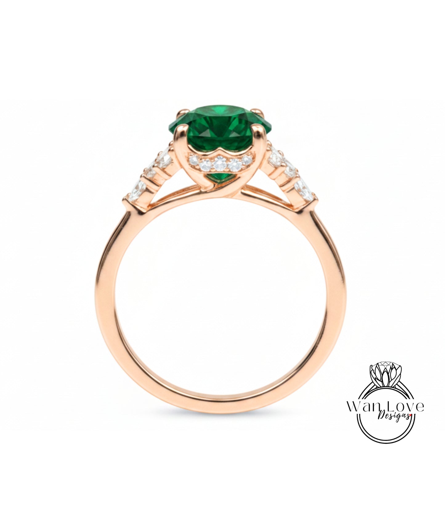 A gold ring with a large green gemstone, possibly an emerald, set in the center.