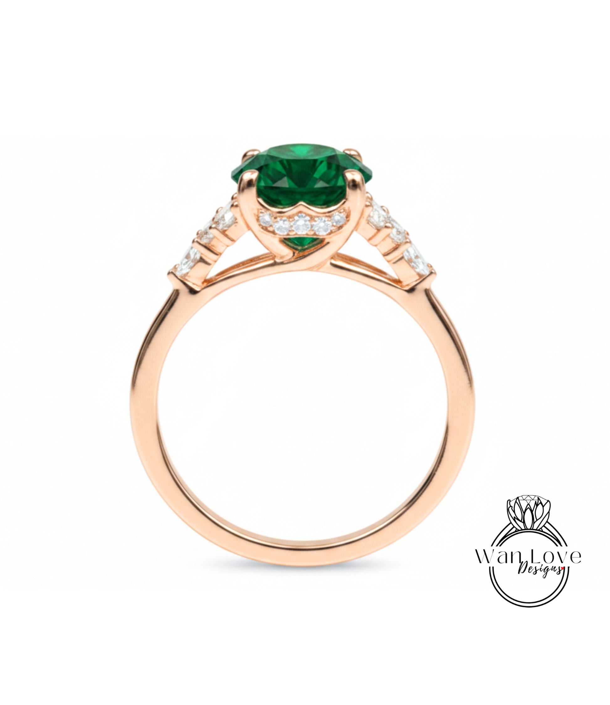 A gold ring with a large green gemstone, possibly an emerald, set in the center.