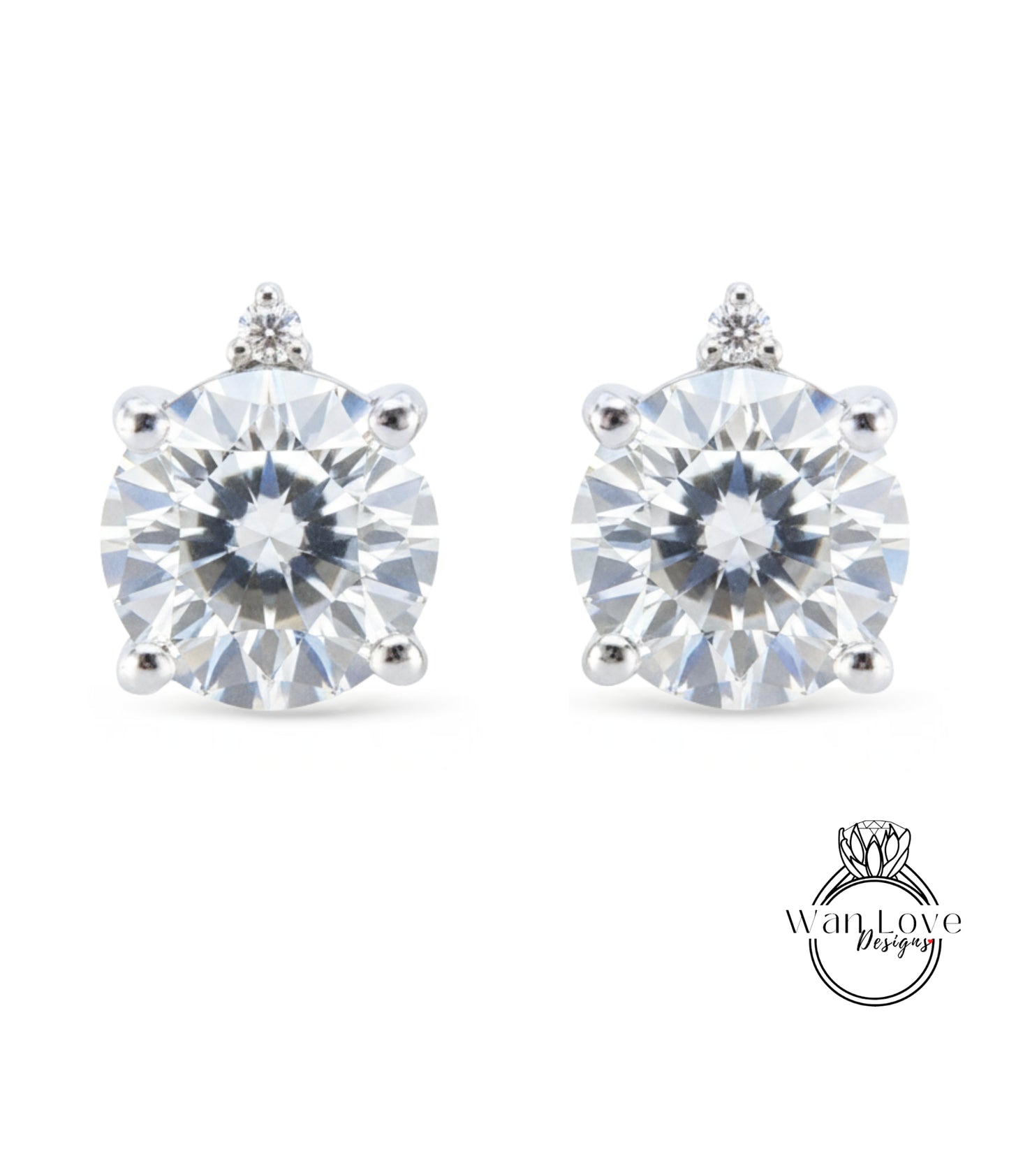 A pair of elegant earrings with a large, brilliant-cut diamond set in a silver-toned metal.