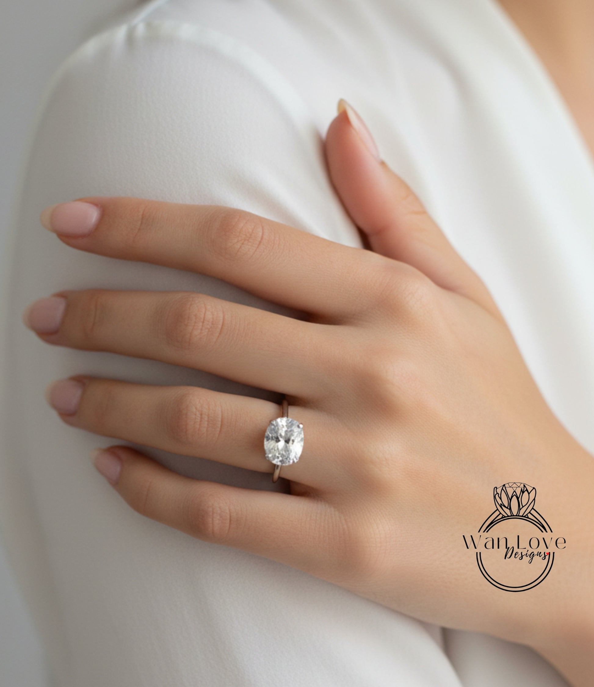 A close-up of a person's hand wearing a large diamond engagement ring.