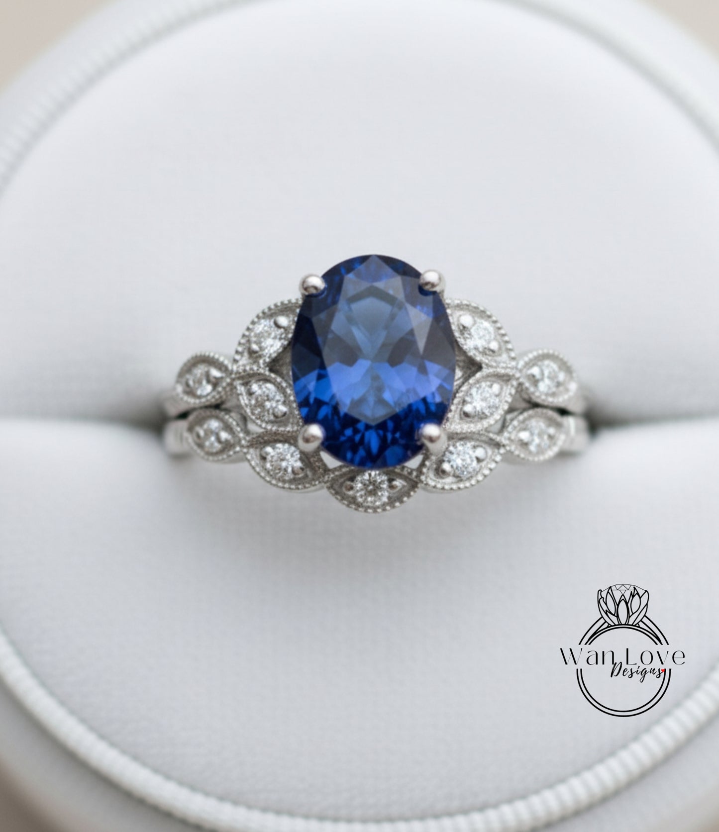 A close-up image of a silver ring with a large blue gemstone, showcasing the intricate design and craftsmanship of the piece.