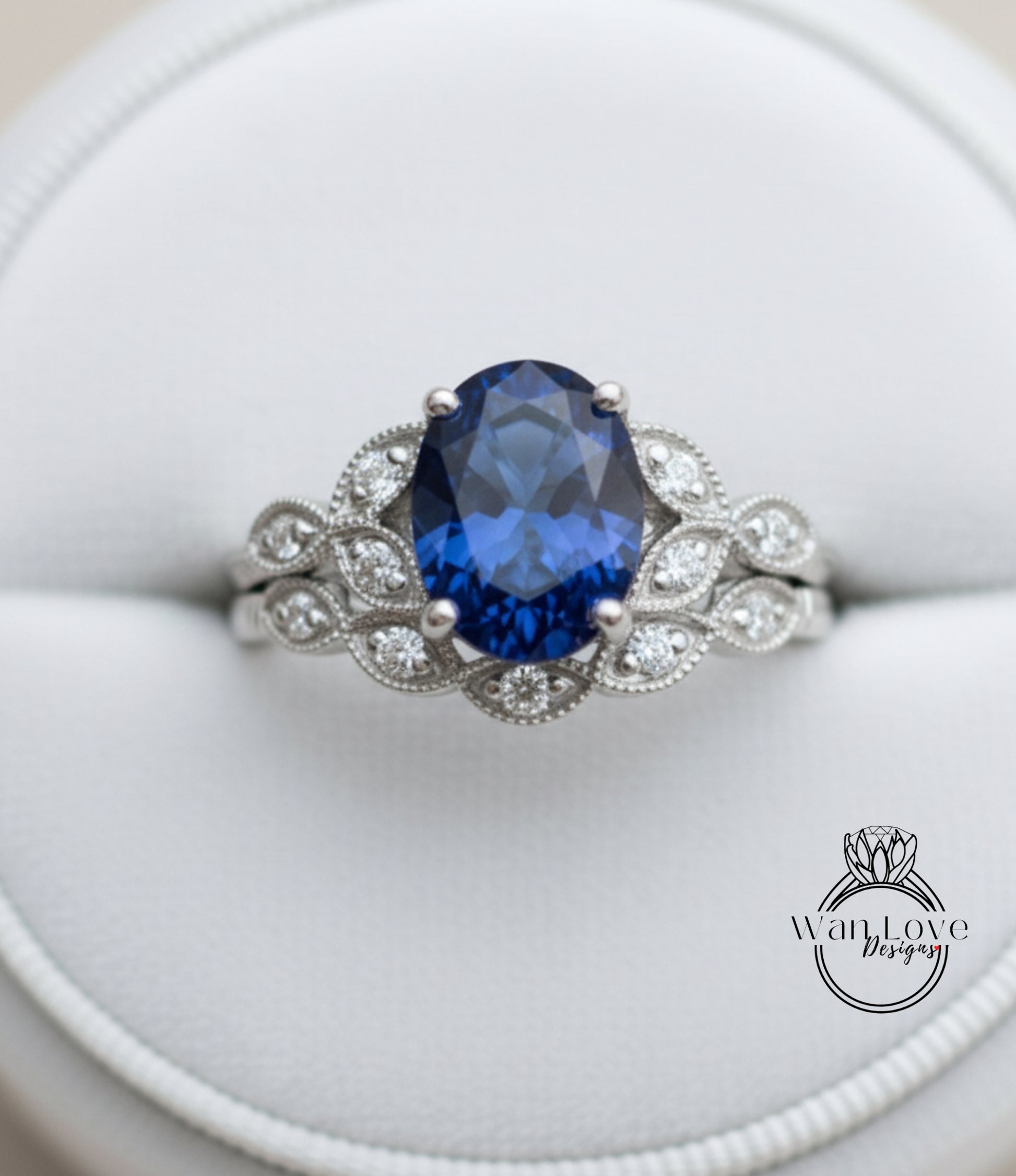 A close-up image of a silver ring with a large blue gemstone, showcasing the intricate design and craftsmanship of the piece.