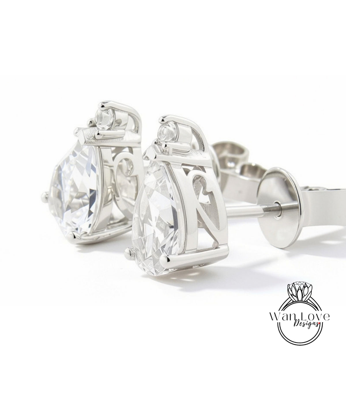 A pair of elegant silver earrings with large, clear gemstones.