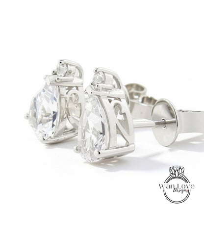 A pair of elegant silver earrings with large, clear gemstones.