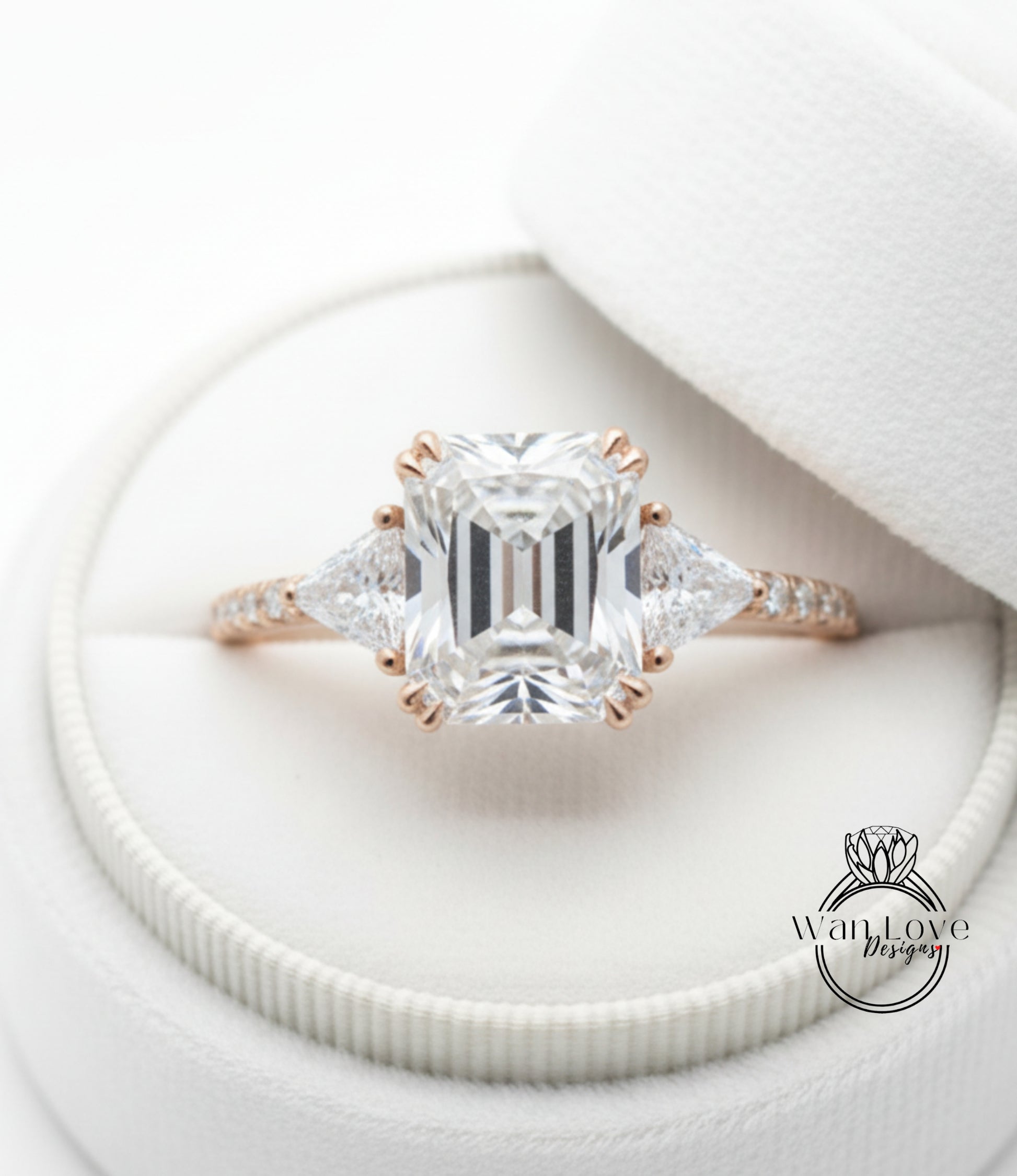 A beautiful diamond engagement ring is displayed in a white box, showcasing the intricate details and sparkling clarity of the diamond.