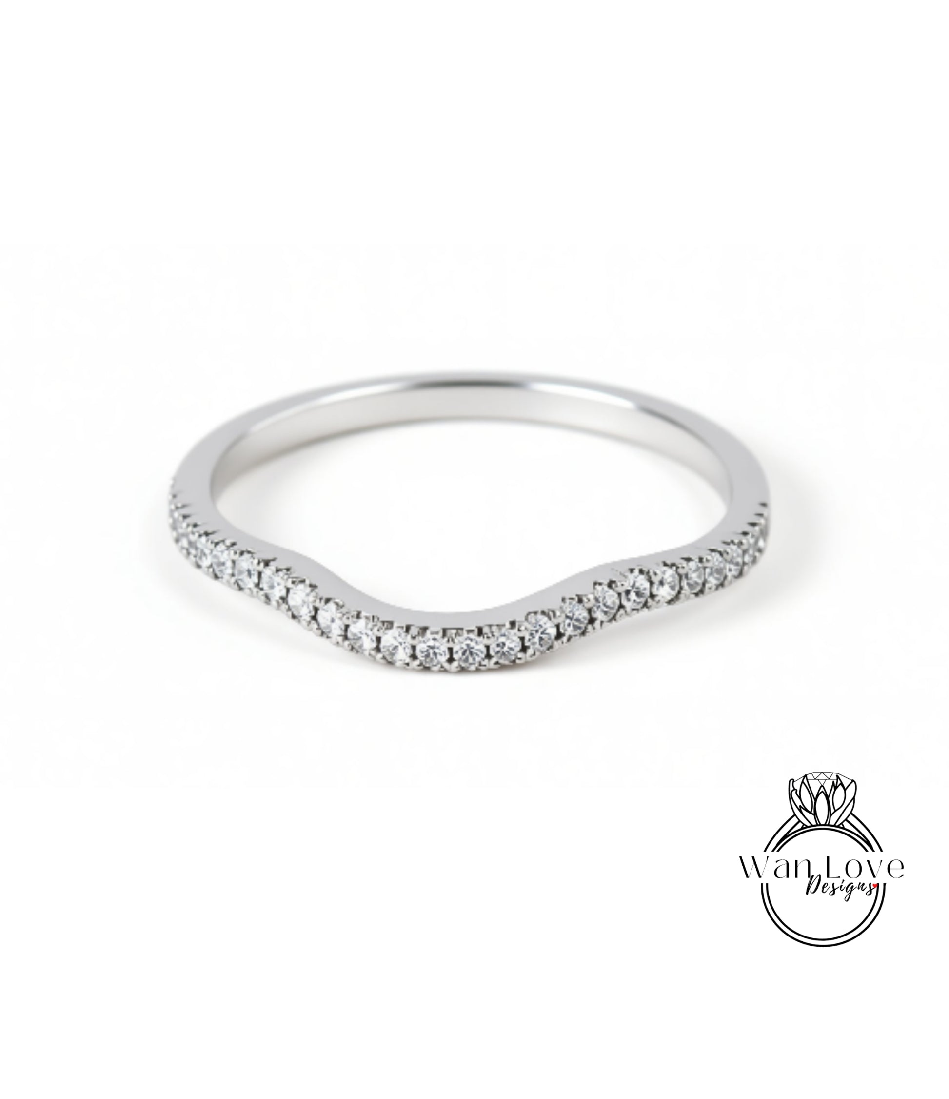 A silver ring with a curved band and small diamonds set in it.