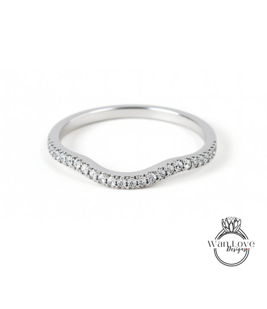 A silver ring with a curved band and small diamonds set in it.