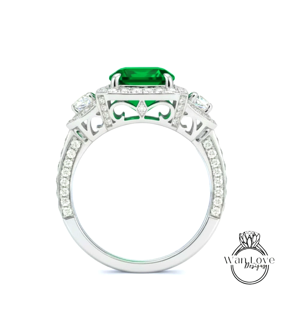 A silver ring with a large green gemstone, surrounded by smaller diamonds.