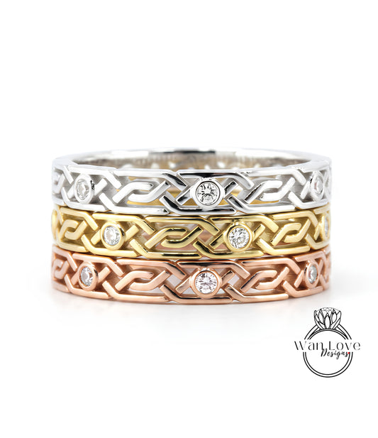 A ring with a Celtic knot design and small diamonds set in it, in various colors including silver, gold, and copper.