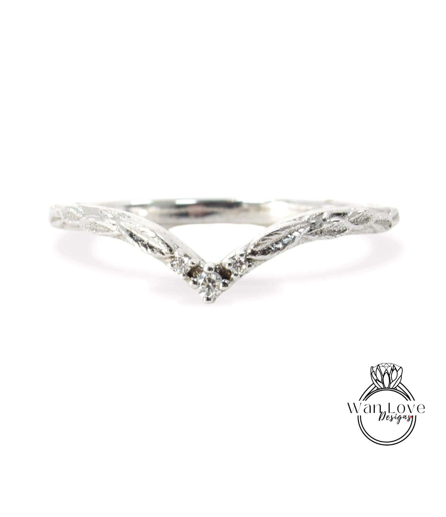 A silver ring with a leaf-like design and a small diamond in the center.