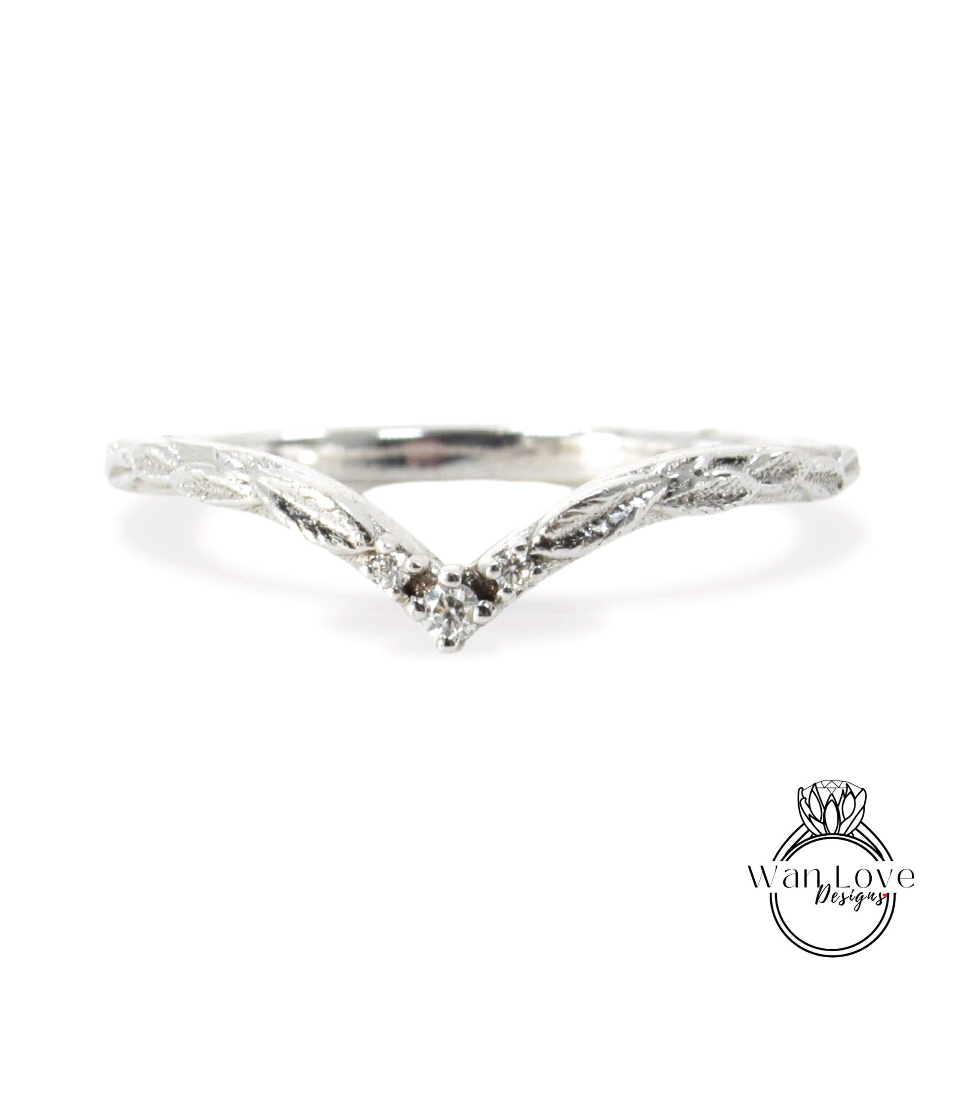 A silver ring with a leaf-like design and a small diamond in the center.