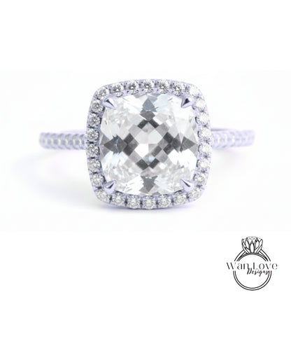 A large, clear diamond engagement ring with a halo of smaller diamonds around the center stone.
