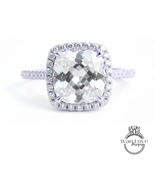 A large, clear diamond engagement ring with a halo of smaller diamonds around the center stone.