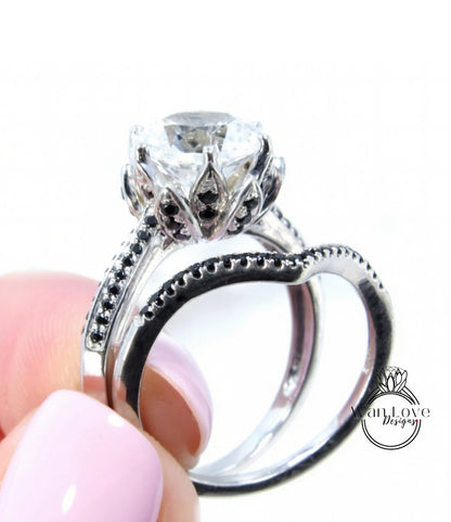 A close-up of a person's hand holding a silver ring with a large, clear gemstone set in a decorative metal band.