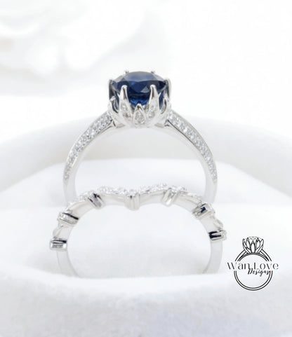 A close-up view of a silver ring with a large blue gemstone, showcasing the intricate design and craftsmanship of the jewelry piece.