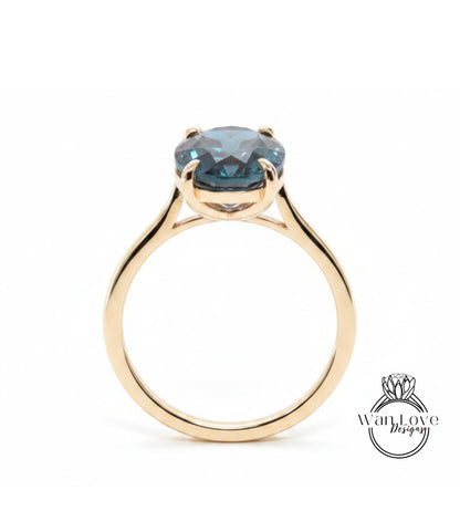 A gold ring with a large blue gemstone set in the center.