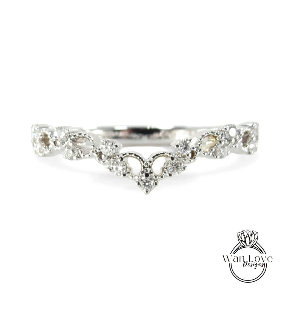 A silver ring with a floral design and a central diamond.