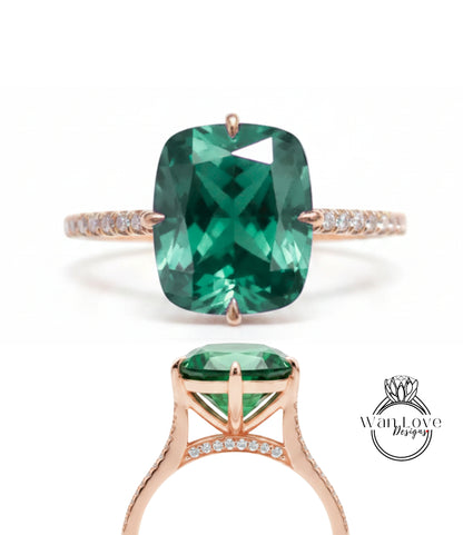 A large, green gemstone engagement ring with a rose gold band and small diamonds.