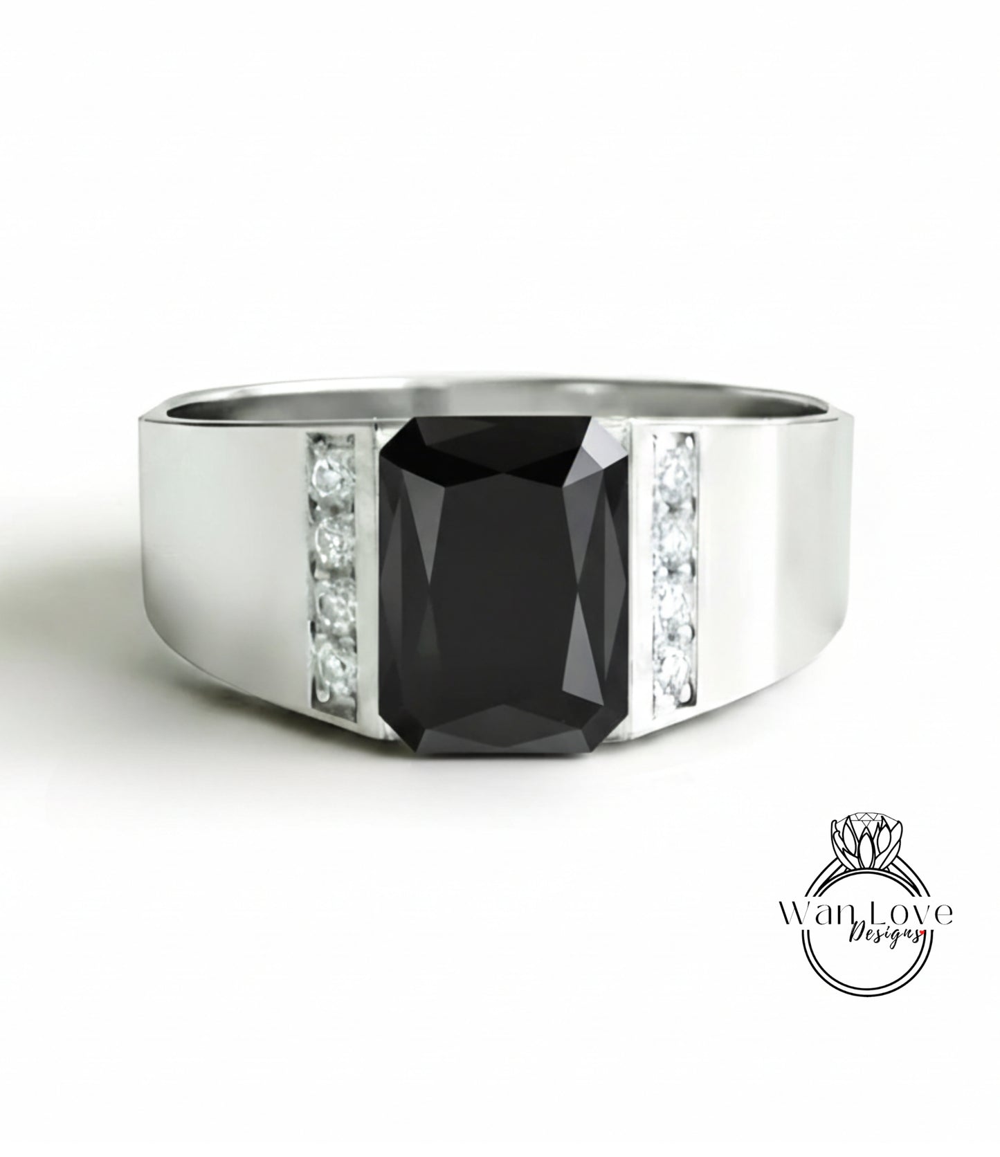 A silver ring with a large black gemstone, likely a diamond, set in the center.