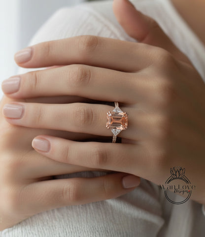A close-up of a person's hand wearing a gold ring with a large, pink gemstone.