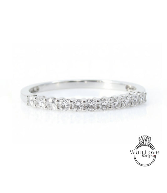A silver ring with a row of small diamonds set in it.