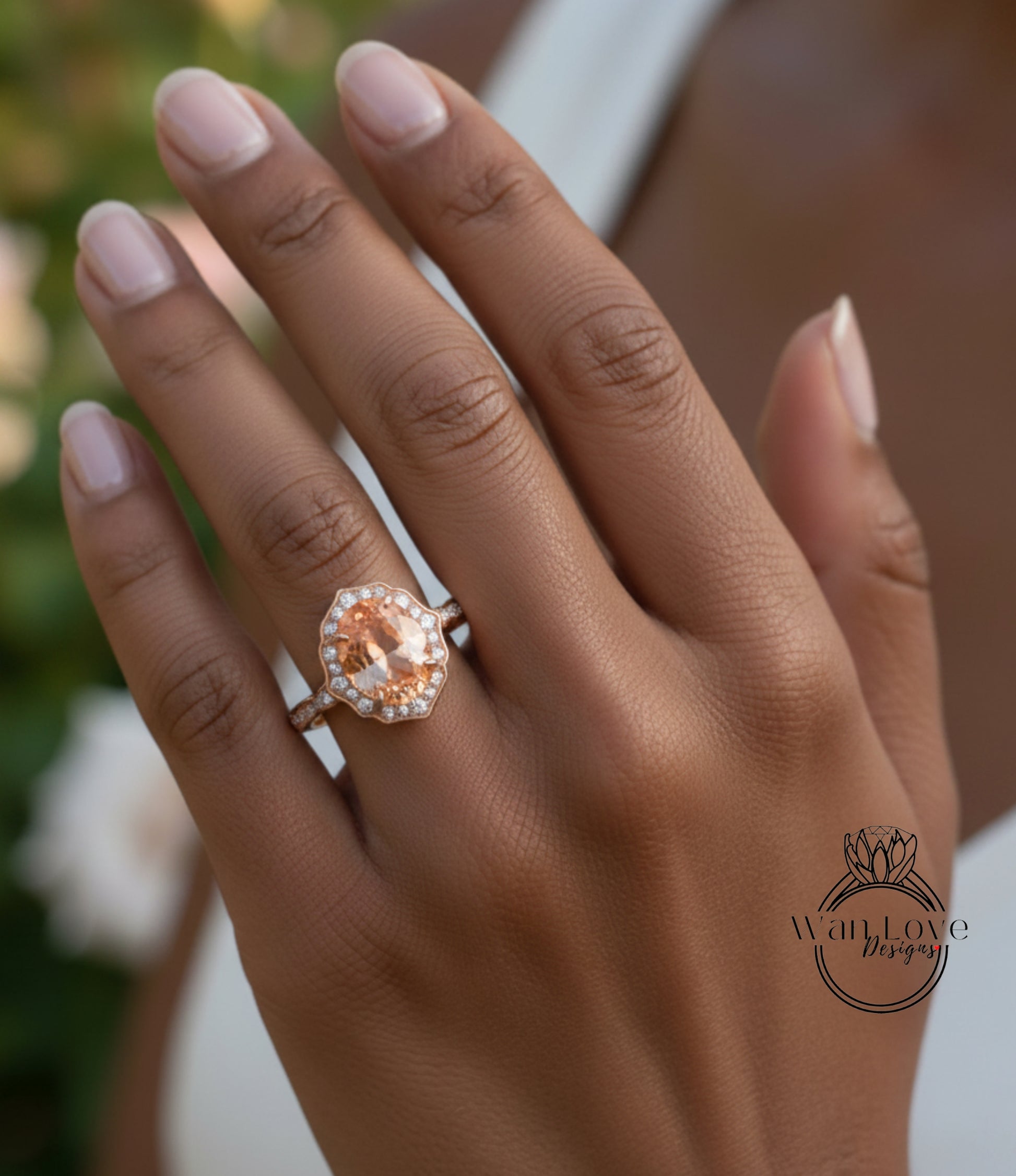 A close-up of a person's hand wearing a large, oval-shaped engagement ring with a halo of smaller diamonds around the center stone.